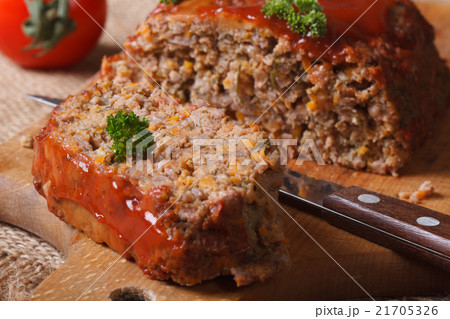 meatloaf with ketchup close-up on chopping board meatloaf with ketchup close-up on chopping board 21705326