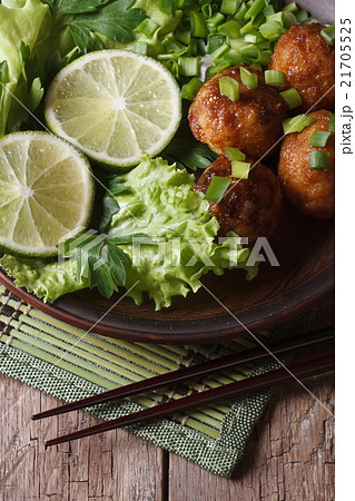 fish balls with lime and salad and chopsticks 21705525