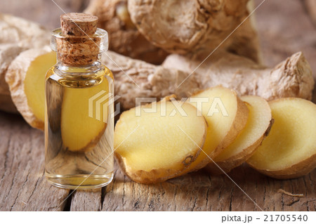 ginger oil in a glass bottle close-up, horizontal 21705540