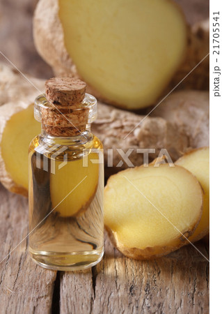 ginger oil in a glass bottle close-up, vertical 21705541