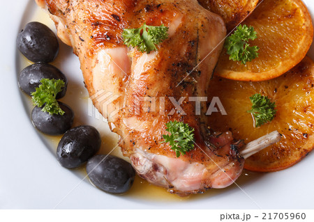 roasted rabbit leg with oranges macro top view roasted rabbit leg with oranges macro top view 21705960