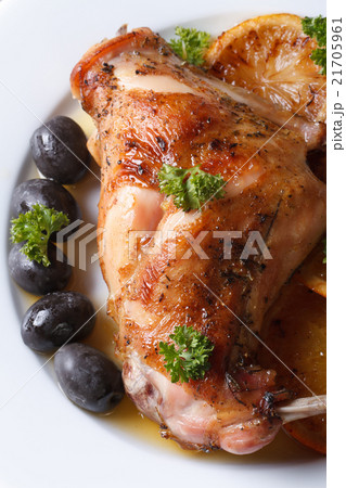 roasted rabbit leg with oranges macro top view 21705961