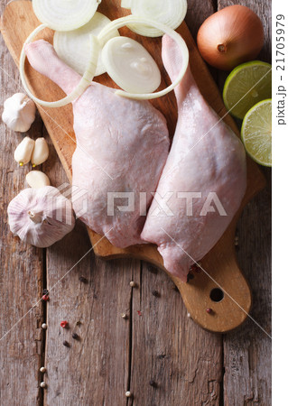 raw duck legs on a cutting board with ingredients raw duck legs on a cutting board with ingredients 21705979