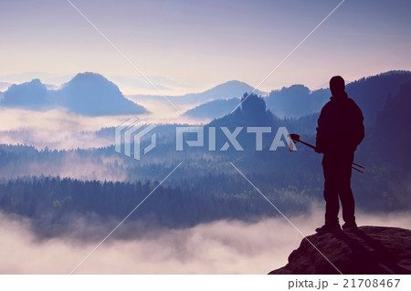 Silhouette of tourist with poles in hand.Sunny day 21708467