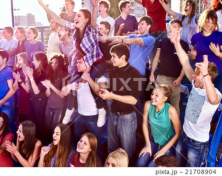 Fans clapping and shouting in the stands. 21708904