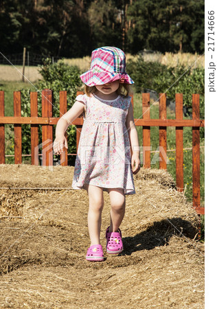 Little girl is walking on the haystack Little girl is walking on the haystack 21714666