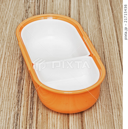 Orange folding plastic food box on the wooden background, kitche 21715436