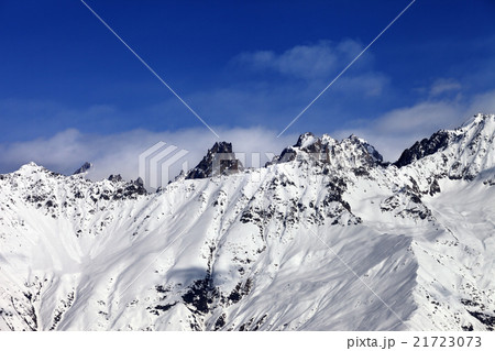 View on snowy mountains at sun day 21723073