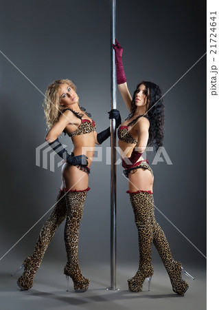 Two young sexy women exercise pole dance Two young sexy women exercise pole dance 21724641