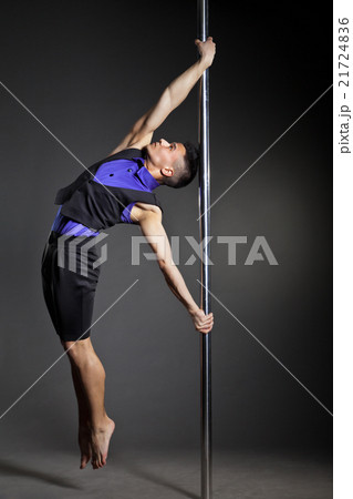 Pole dance man over black background with flashes 21724836