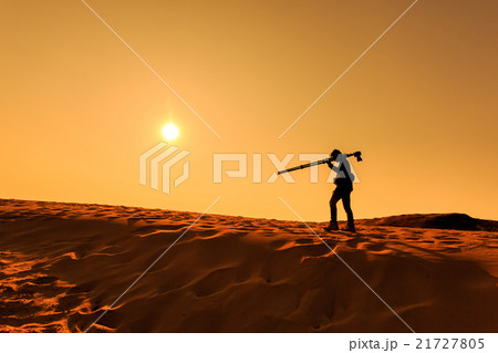 A man walking on sand desert A man walking on sand desert 21727805
