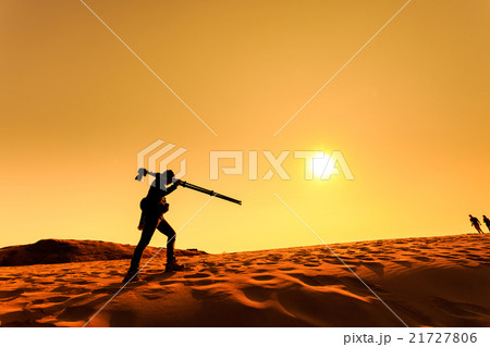 A man walking on sand desert A man walking on sand desert 21727806