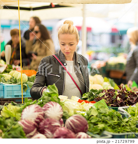 Woman buying vegetable at local food market.  21729799