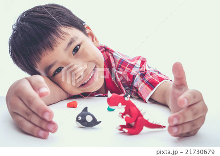 Child show his works from clay, on white. 21730679