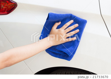 Woman cleaning car using microfiber cloth 21733670