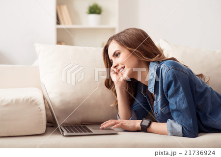 Positive girl lying on the sofa 21736924