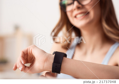 Cheerful girl wearing her wrist watch 21737048