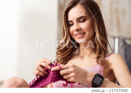 Smiling girl knitting  21737098