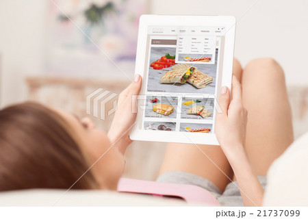Pleasant girl using tablet 21737099