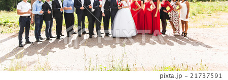 bride and groom standing with guests in garden bride and groom standing with guests in garden 21737591
