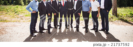 bride and groom standing with guests in garden bride and groom standing with guests in garden 21737592