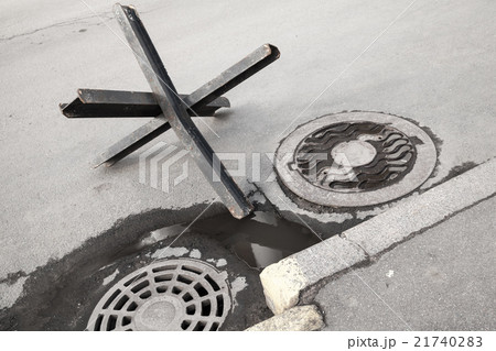 Black steel street barrier on asphalt urban road 21740283
