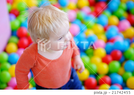 Happy toddler boy playing in ball pit Happy toddler boy playing in ball pit 21742455