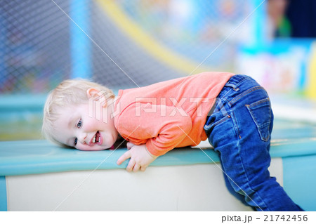 Active toddler boy playing at indoors playground 21742456
