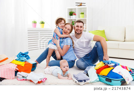 happy family mother, father and two children packed suitcases fo 21743874