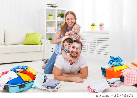 happy family mother, father and two children packed suitcases fo 21743875