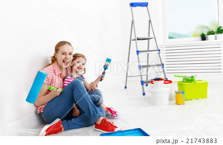 happy family mother and child daughter making repairs, paint wal 21743883