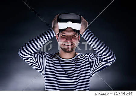 Man wearing virtual reality goggles. Studio shot 21744044