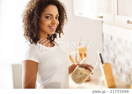 Cheerful girl cooking breakfast Cheerful girl cooking breakfast 21755099