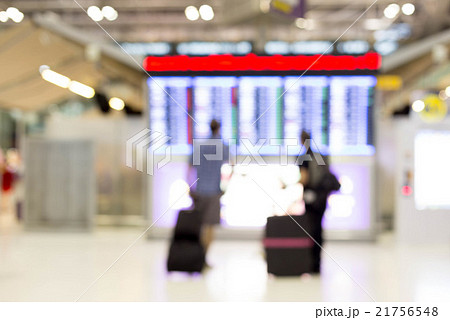 Blur image of people looking at timetable screen 21756548