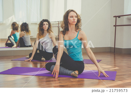 Two slim women are doing yoga in studio 21759573
