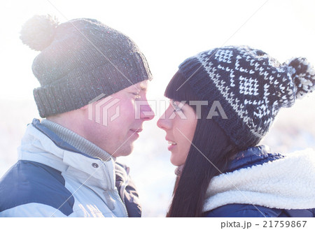 Young couple looking each other in winter Young couple looking each other in winter 21759867