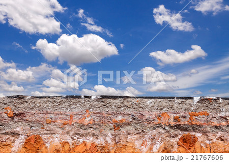 Layer of soil beneath asphalt road with blue sky 21767606
