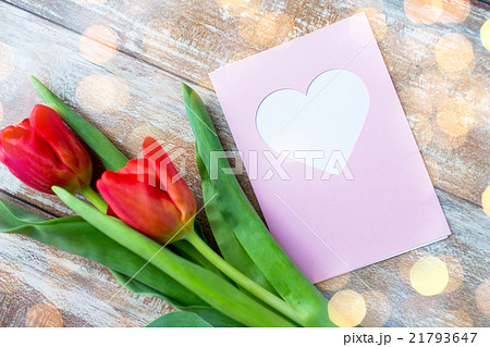 close up of tulips and greeting card with heart 21793647