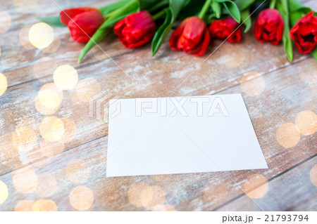 close up of red tulips and blank paper or letter 21793794