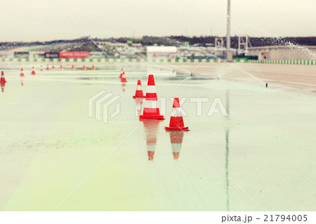 traffic cones and sprinklers on wet speedway 21794005