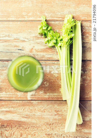 close up of fresh green juice glass and celery 21794096