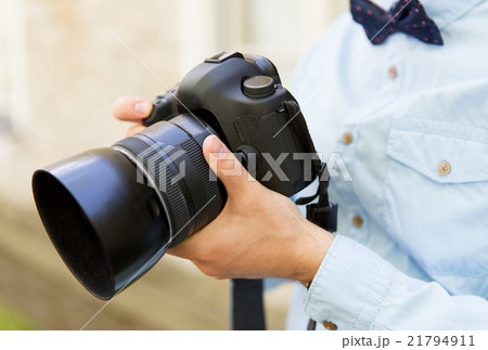 close up of male photographer with digital camera 21794911