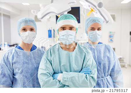 group of surgeons in operating room at hospital 21795317