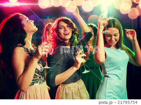 smiling friends with glasses of champagne in club 21795754