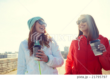 happy teenage girls with coffee cups on street 21795797