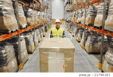 smiling man in hardhat loading cargo at warehouse smiling man in hardhat loading cargo at warehouse 21796161