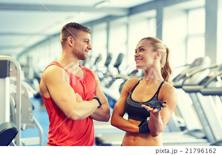 smiling man and woman talking in gym smiling man and woman talking in gym 21796162