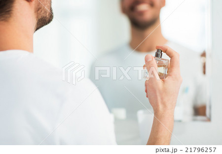close up of man perfuming with perfume at bathroom close up of man perfuming with perfume at bathroom 21796257