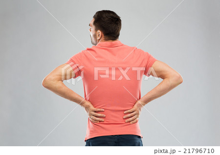 unhappy man suffering from backache at home unhappy man suffering from backache at home 21796710