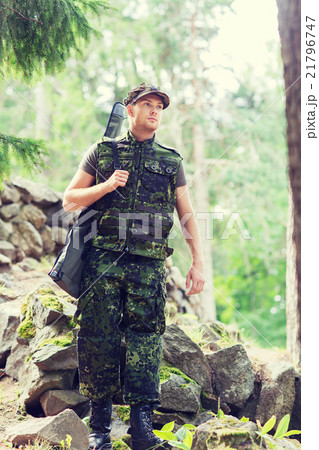 young soldier or hunter with gun in forest 21796747